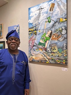 Oyemi Tube standing in front of his picture